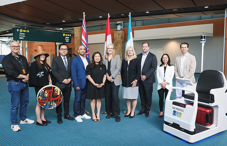 Stakeholders celebrate the debut of A&K Robotics' Cruz pods at Vancouver Airport.