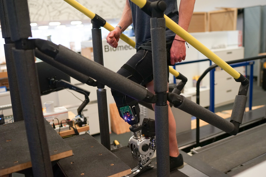 a person walking up stairs using a prosthetic leg.