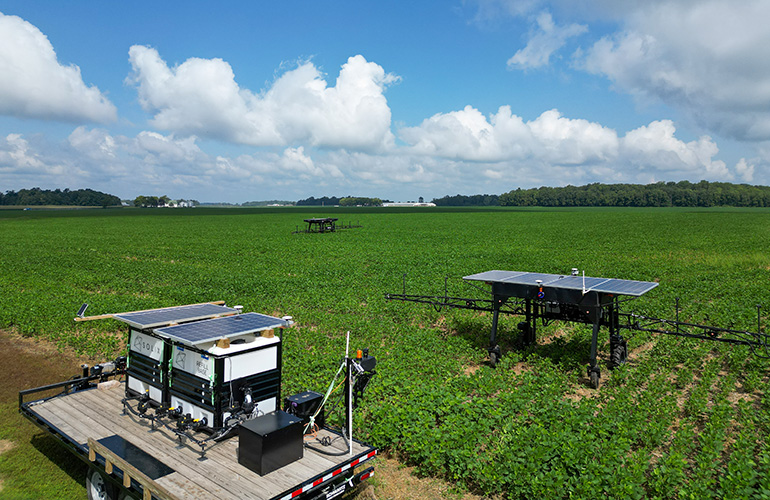 Solix robot and docking station in a field.