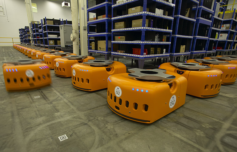 Kiva’s pioneering mobile robots and mini shelves in a warehouse.