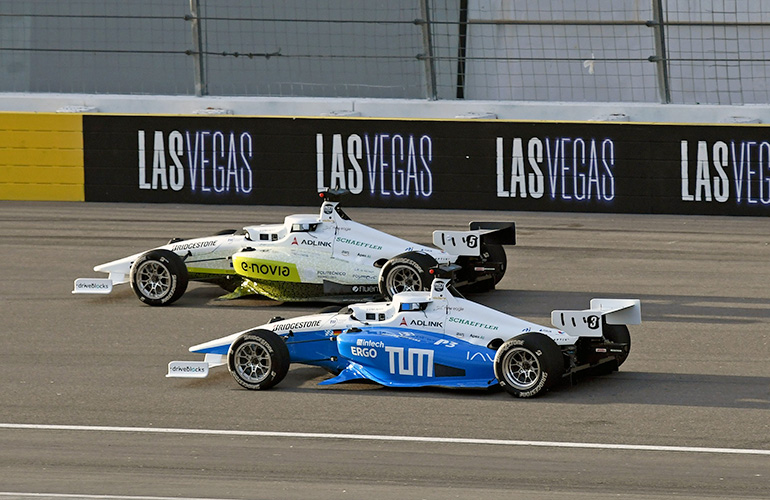 two racecars passing on the track.